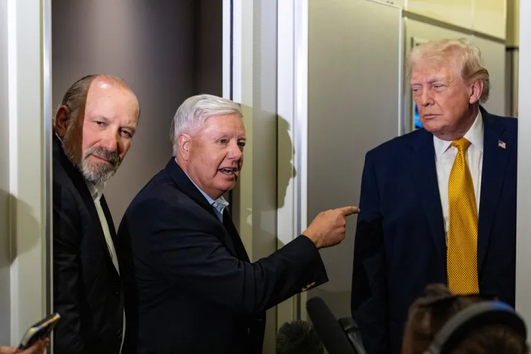 President Donald Trump, accompanied by Commerce Secretary Howard Lutnick, left, and Sen. Lindsey Graham