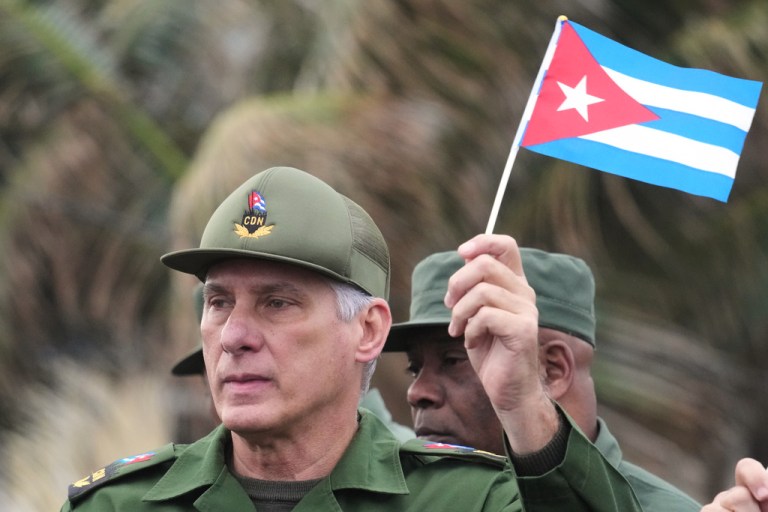 Cuban President Miguel Diaz-Canel marches during a rally