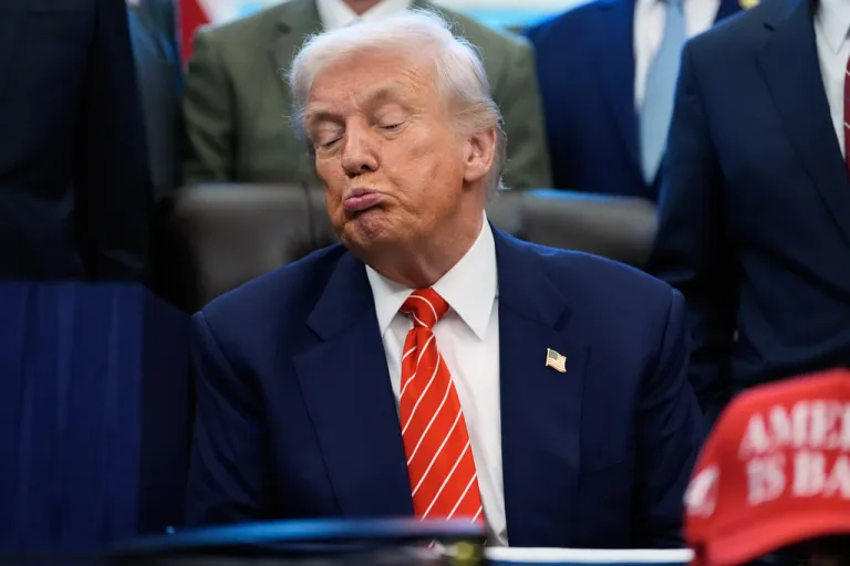 President Donald Trump listens before signing a spending bill in the Oval Office