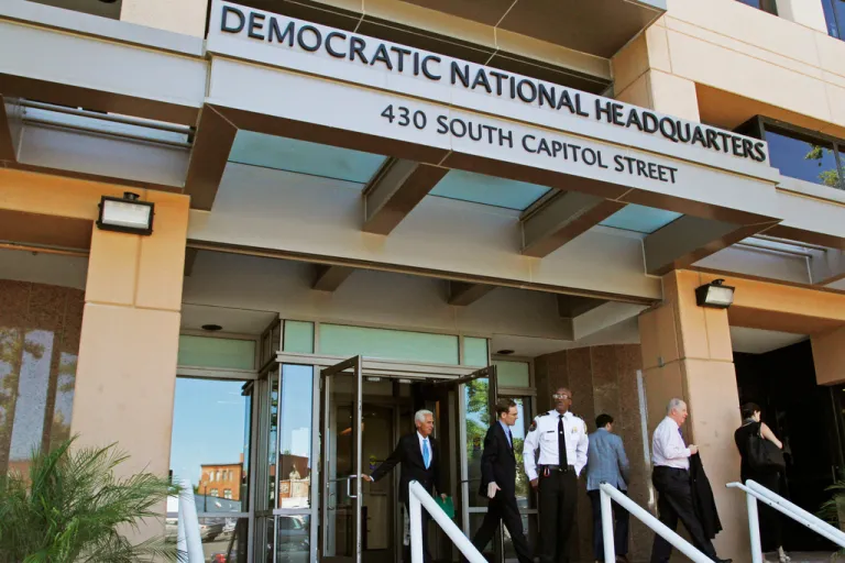 People stand outside the Democratic National Committee headquarters in Washington, June 14, 2016. (AP Photo/Paul Holston, File)