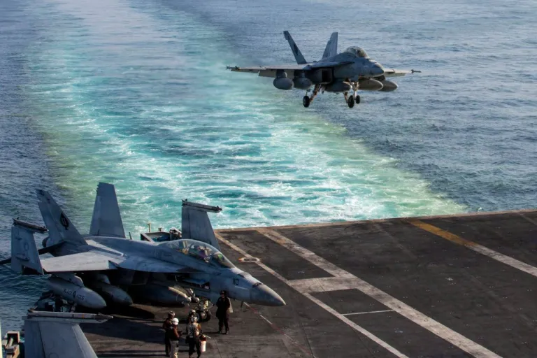 This image provided by U.S. Central Command shows a F/A-18E Super Hornet preparing to make an arrested landing on the USS Abraham Lincoln (CVN 72) after a mission in support of Operation Epic Fury, on Saturday, Feb. 28, 2026. (U.S. Navy via AP)