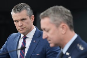 Pete Hegseth listens to Chairman of the Joint Chiefs of Staff Gen. Dan Caine, during a press briefing