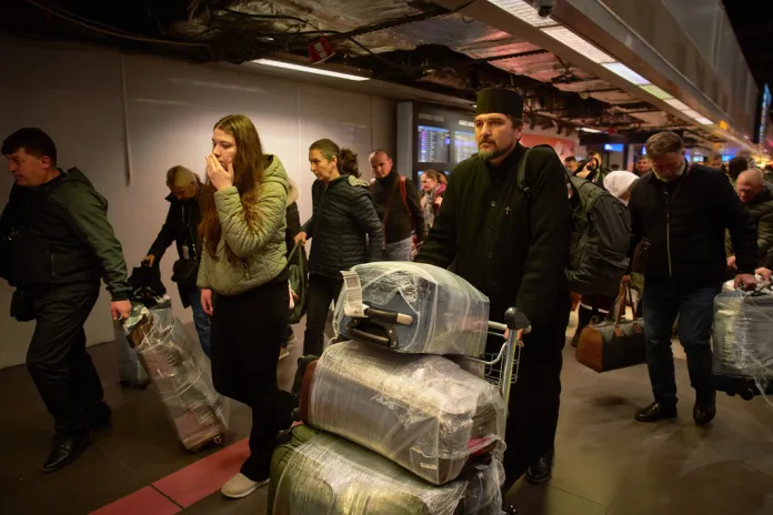 Travelers land in Romania after being evacuated from Israel.