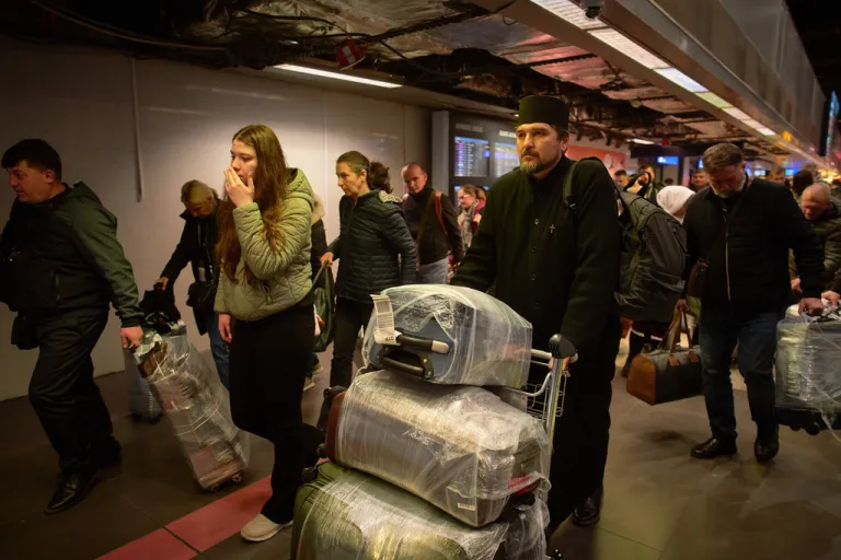 Travelers land in Romania after being evacuated from Israel.