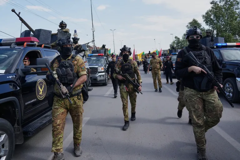 Members from the Popular Mobilization Forces attend the funeral of fighters from Kataib Hezbollah, who were killed in a U.S. airstrike