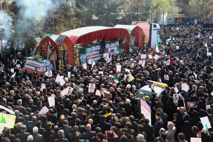 Iranians attend a funeral for IRGC members killed by US-Israeli strikes