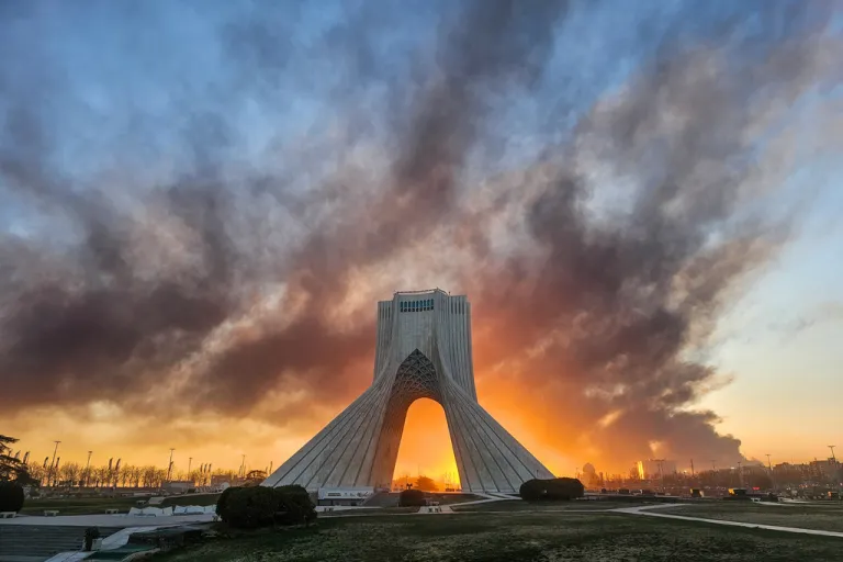 Smoke rises behind the Azadi (Freedom) monument in Tehran, Iran, on March 3, 2026, following the U.S.-Israeli military attack. (Davoud Ghahrdar/ISNA via AP, File)