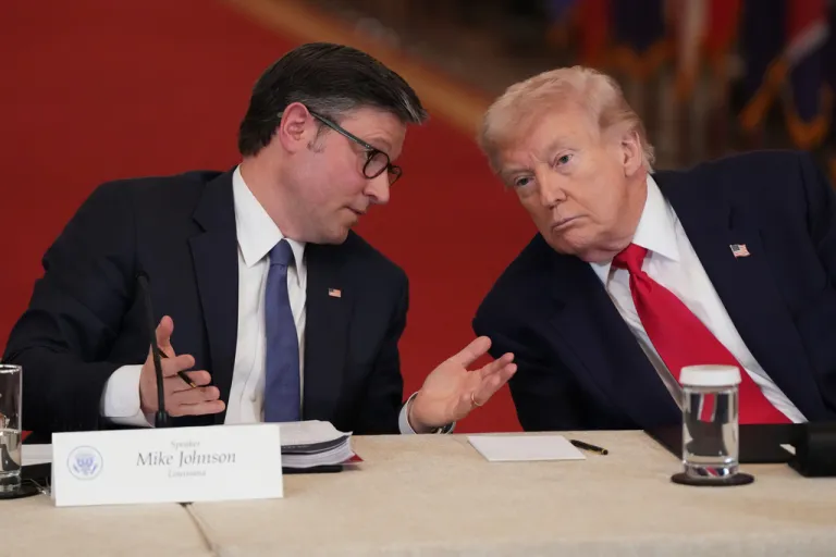 House Speaker Mike Johnson, left, speaks with President Donald Trump