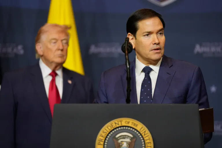 Marco Rubio speaks from the podium with Trump behind him