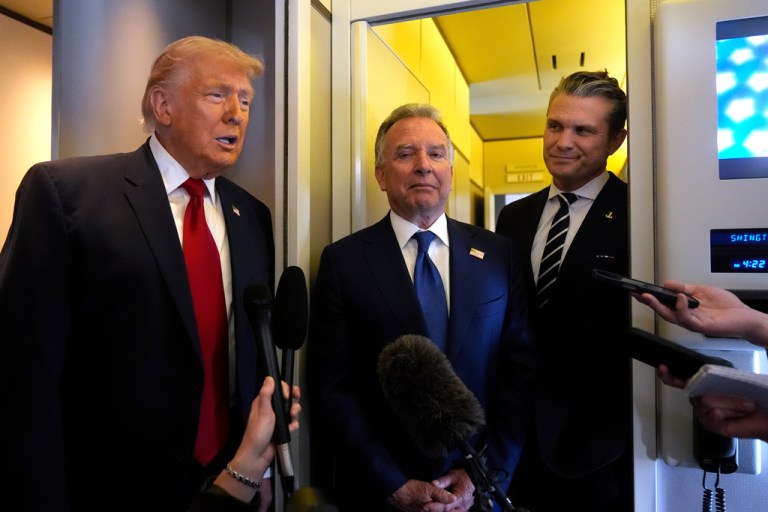 President Donald Trump speaks to reporters as White House Special Envoy to the Middle East Steve Witkoff, center, and Defense Secretary Pete Hegseth listen while traveling aboard Air Force One en route from Dover Air Force Base, Del., to Miami, Saturday, March 7, 2026. (AP Photo/Mark Schiefelbein)