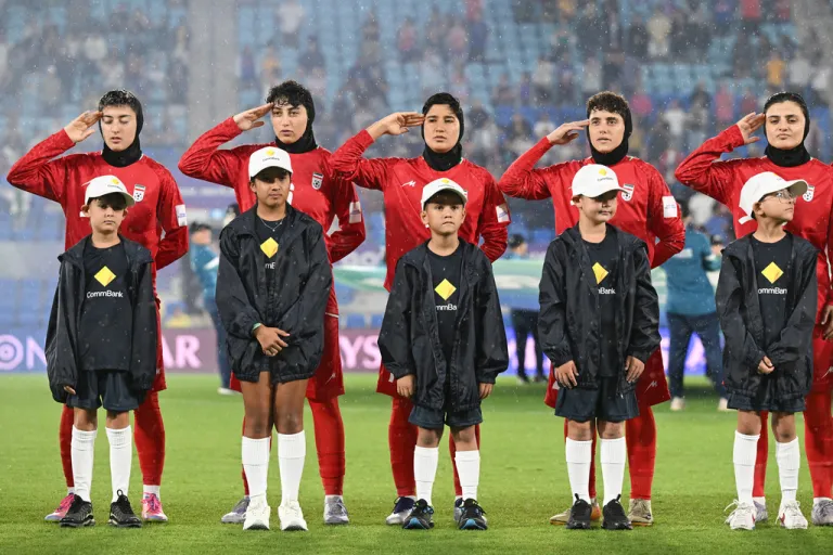 Iran players react during their national anthem ahead of the Women's Asian Cup soccer match.