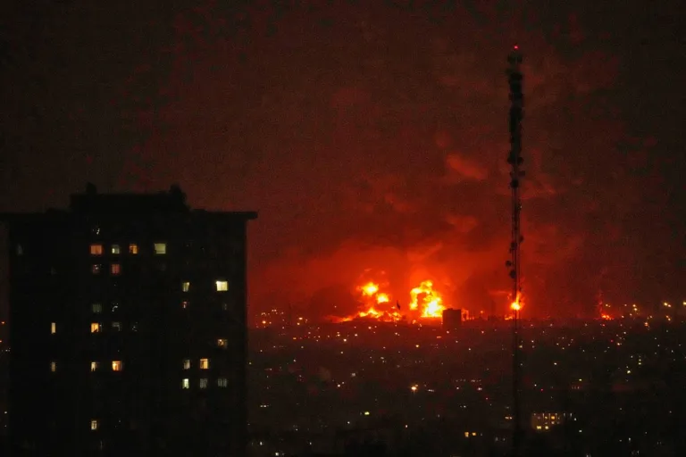 Flames rise from an oil storage facility south of the capital Tehran as strikes hit the city during the U.S.–Israel military campaign, Iran, Saturday, March 7, 2026.