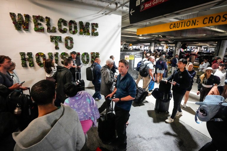 Airline passengers wait in long lines outside the terminal to get through the TSA security screening at William P. Hobby Airport in Houston, Sunday, March 8, 2026. (Brett Coomer/Houston Chronicle via AP)