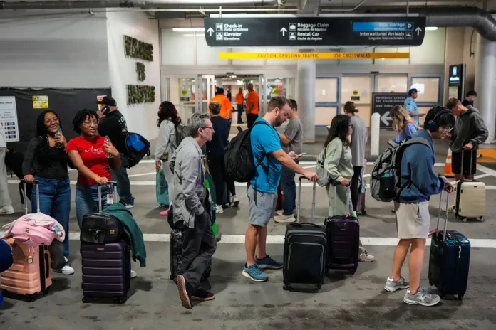 Airline passengers wait in long lines outside the terminal to get through the TSA security screening at William P. Hobby Airport in Houston, Sunday, March 8, 2026. (Brett Coomer/Houston Chronicle via AP)