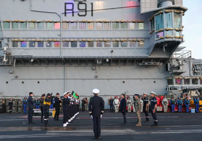 French President Emmanuel Macron, center right, visits the French aircraft carrier Charles de Gaulle
