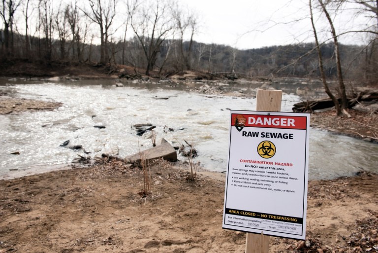 A warning sign is seen at the sight of a massive pipe rupture as sewage flows into the Potomac River.