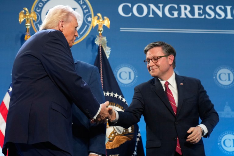 President Donald Trump shakes hands with House Speaker Mike Johnson (R-LA).