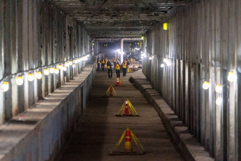 Metropolitan Transportation Authority workers are seen during a media tour of subway tunnels built in the 1970s that will be part of the Second Ave Subway expansion project