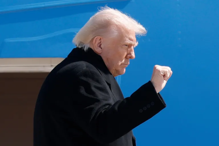 President Donald Trump gestures as he boards Air Force One