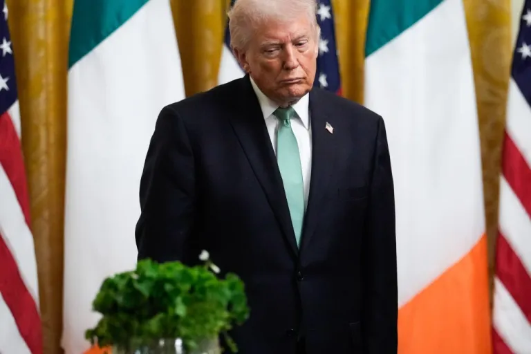 President Donald Trump listens with his eyes closed before Ireland's Prime Minister Micheál Martin presents him with a bowl of shamrocks during a St. Patrick's Day event in the East Room of the White House, Tuesday, March 17, 2026, in Washington. (AP Photo/Julia Demaree Nikhinson)