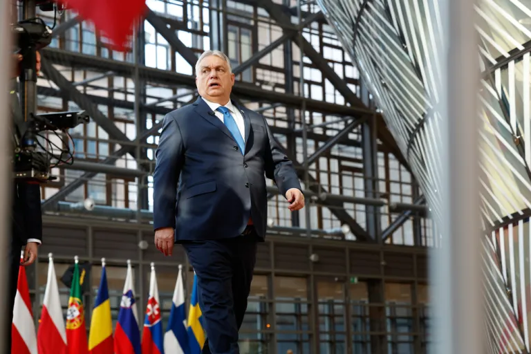 Orban walks at the entrance of the European Summit