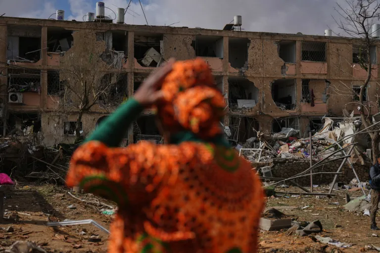 People survey a site that was struck by an Iranian missile in Dimona, southern Israel.