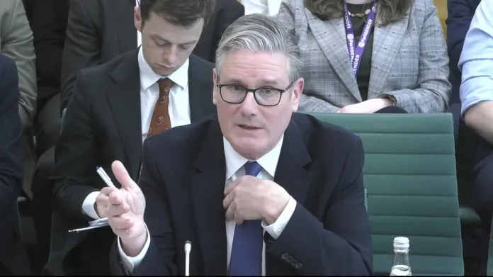 Starmer speaks while seated at the House of Commons