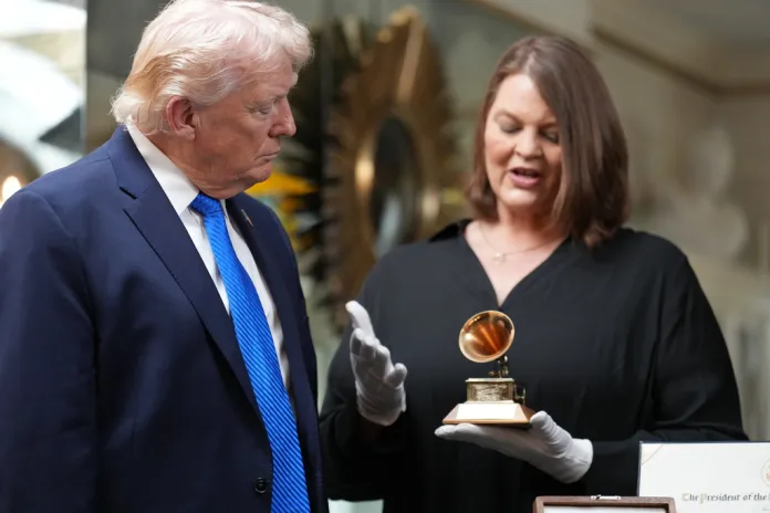 President Donald Trump is shown a Grammy award won by Elvis Presley in the living room at Graceland