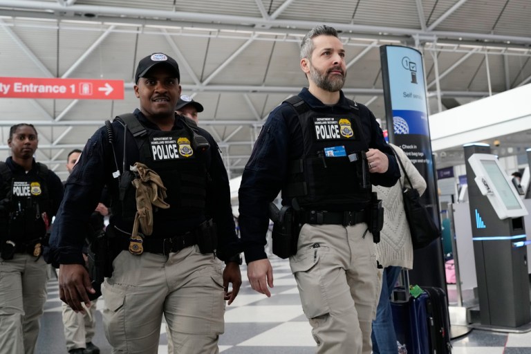 U.S. Immigration and Customs Enforcement (ICE) agents walk though the terminal 1 at O'Hare International Airport in Chicago, Tuesday, March 24, 2026. (AP Photo/Nam Y. Huh)