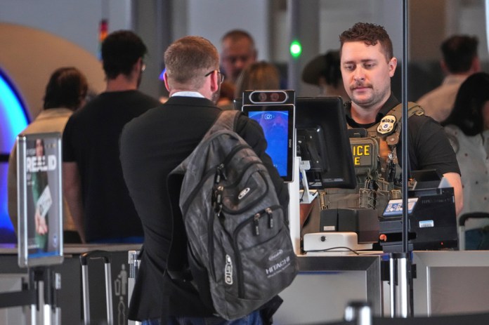 An ICE officer mans a TSA checkpoint at Pittsburgh International Airport in Imperial, Pa., on Thursday, March 26, 2026. (AP Photo/Gene J. Puskar)