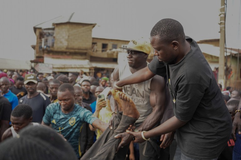 People carry a body of a gunmen attack victim in Gari Ya Waye community in Jos North Nigeria, Monday, March 30, 2026. (AP Photo/Samson Omale)