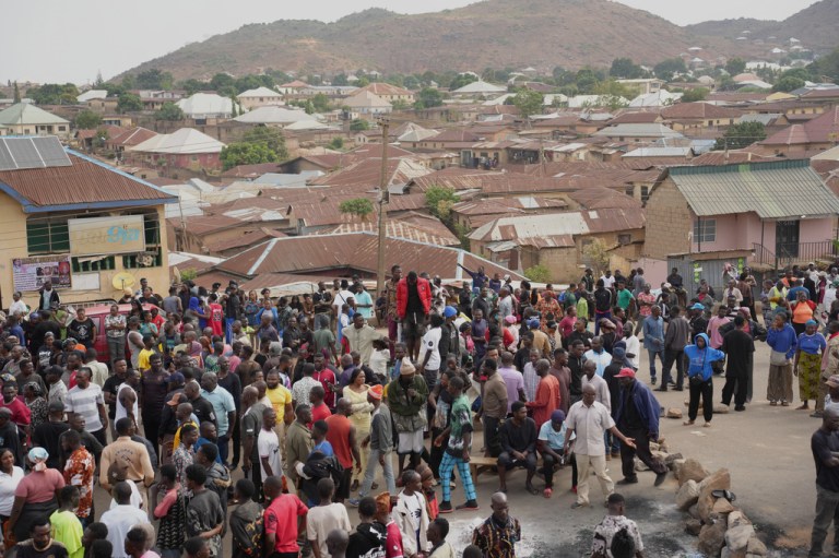 People gather at the scene of Sunday night gunmen attack in Gari Ya Waye community in Jos, Nigeria.