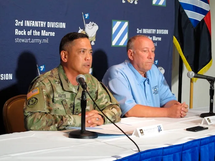 Army Maj. Gen. Antonio Aguto, left, and Army accident investigator Michael Barksdale hold a news conference, Monday, Oct. 21, 2019, at Fort Stewart, Ga., about a training accident that killed three soldiers and injured three others. Aguto said the soldiers' armored vehicle rolled off a bridge and landed upside down in a stream during a training exercise being conducted before dawn the day before. The cause of the fatal crash is being investigated. (AP Photo/Russ Bynum)