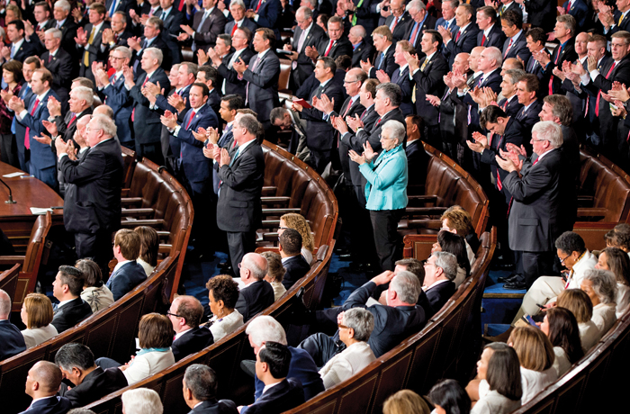 Democrats stay seated as Republicans give a standing ovation for President Donald Trump.