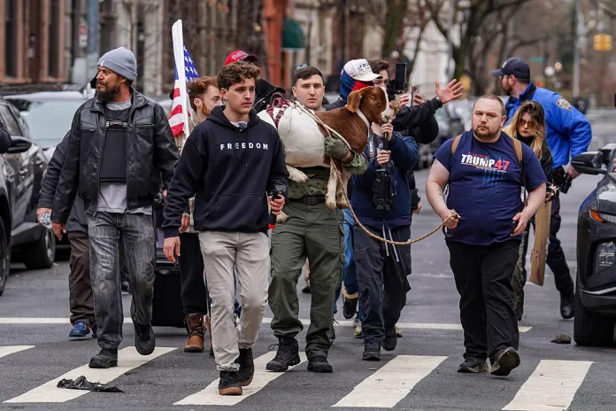Right-wing influencer Jake Lang carries a goat at a protest organized by the influencer on March 7, 2026 in New York City.