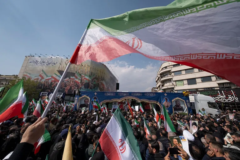 A truck carries the coffins of Ali Larijani, Secretary of the Supreme National Security Council, and Gholamreza Soleimani, commander of the Paramilitary Basij Forces, during a funeral for Larijani, Soleimani, and the crew of the sunken IRIS Dena warship in Tehran, Iran, on March 18, 2026. The Iranian Navy frigate IRIS Dena was torpedoed and sunk by the United States Navy's Los Angeles-class submarine USS Charlotte in the Indian Ocean during the 2026 Iran conflict. (Photo by Morteza Nikoubazl/NurPhoto via Getty Images)