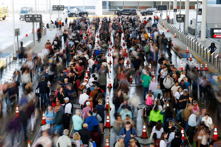 Travelers wait in line at a Transportation Security Administration (TSA) checkpoint at George Bush Intercontinental Airport (IAH) in Houston, Texas, US, on Thursday, March 26, 2026. The Transportation Security Administration warned that airport security is under severe strain as a weeks-long Department of Homeland Security funding shutdown drives staffing shortages, long wait times and mounting disruptions across the US. Photographer: Mark Felix/Bloomberg via Getty Images
