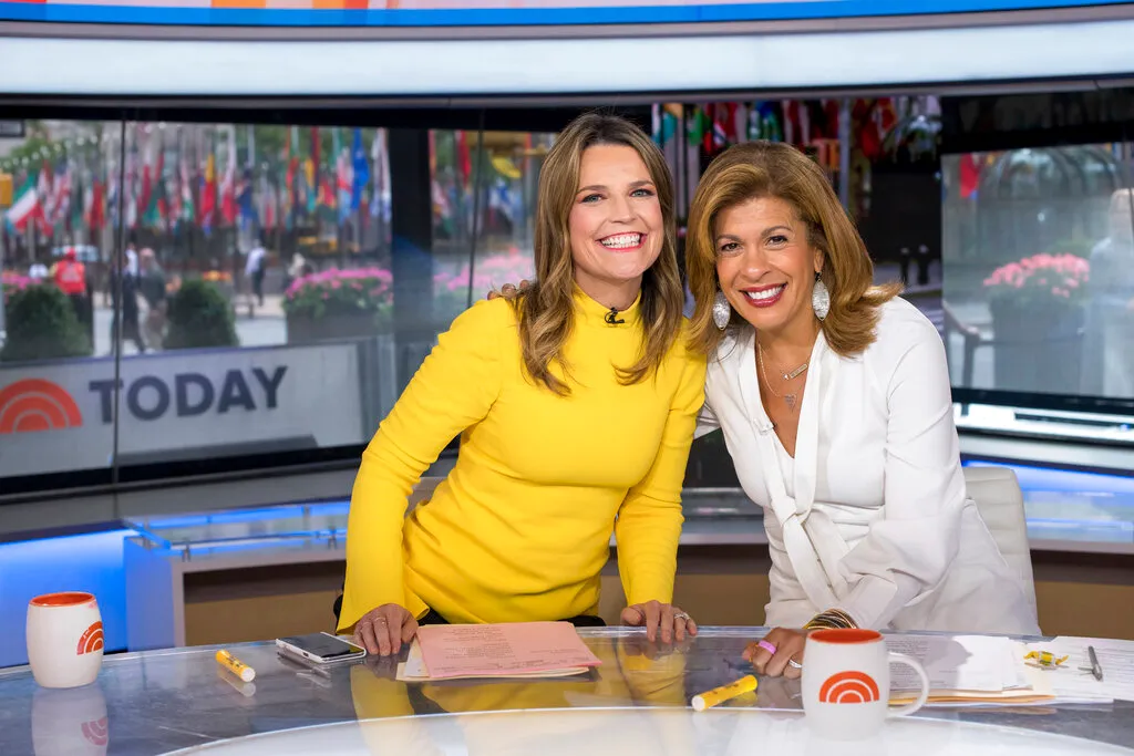 Co-anchors Savannah Guthrie, left, and Hoda Kotb pose on "Today" show set at NBC Studios on June 27, 2018, in New York. On Wednesday NBC addressed the mystery of Kotb's absence on the program. Kotb, who has been absent from the morning show last week and this week, is dealing with an unspecified “family health matter." Guthrie, who left mid-show on Tuesday, tested positive for COVID. (Photo by Charles Sykes/Invision/AP, File)