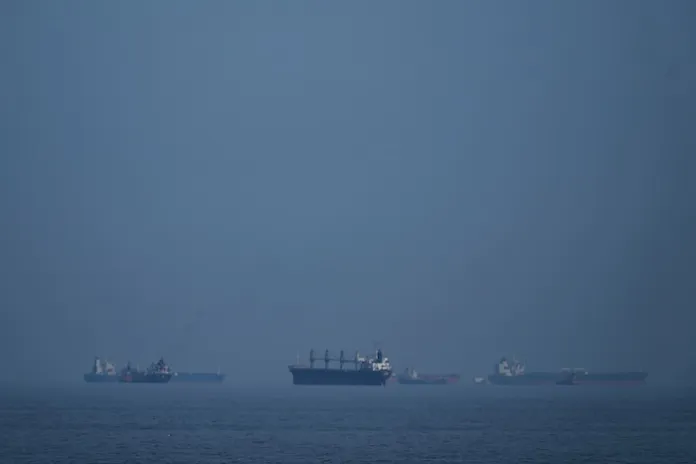Oil tankers and cargo ships line up in the Strait of Hormuz as seen from Khor Fakkan, United Arab Emirates, Wednesday, March 11, 2026. (AP Photo/Altaf Qadri)