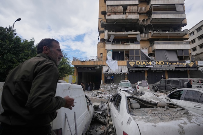 People check the site of an Israeli airstrike that hit an apartment building in suburban Beirut, Lebanon.