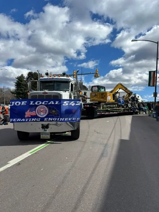 A large truck with a banner on it.