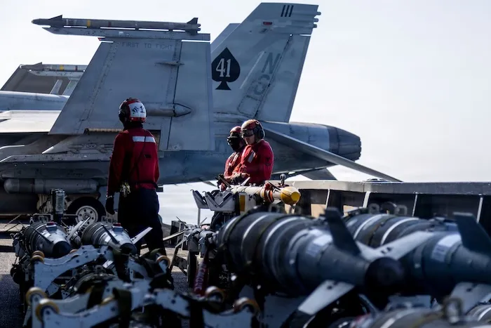 This image provided by U.S. Central Command shows Navy sailors looking over ordnance on the flight deck of the USS Abraham Lincoln (CVN 72) in support of Operation Epic Fury on Monday, March 2, 2026. (U.S. Navy via AP)