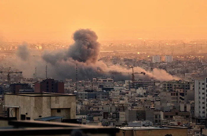 A plume of smoke rises following a U.S.-Israeli military strike in Tehran, Iran on March 3, 2026. (Vahid Salemi/AP)