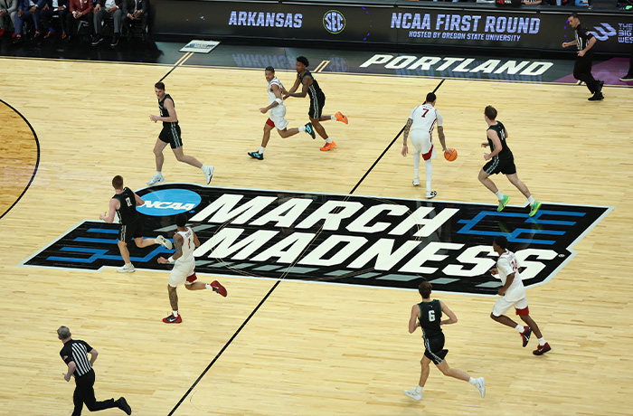 Hawaii and Arkansas players run down court as Arkansas forward Trevon Brazile (7) dribbles the ball during the second half in the first round of the NCAA college basketball tournament in Portland, Oregon, on March 19. (Amanda Loman/AP)