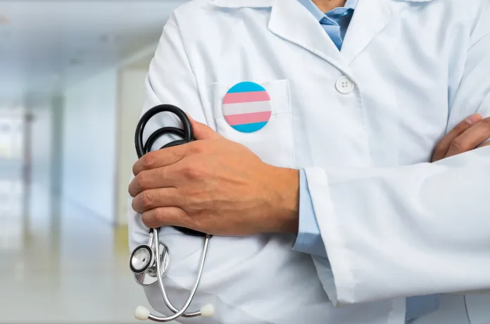 doctor in white lab coat with stethoscope and transgender badge on pocket concept at hospital