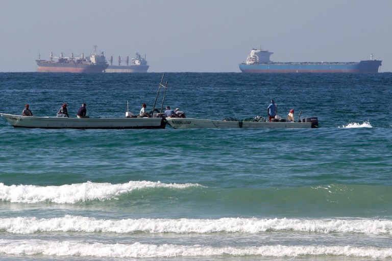 FILE - Fishermen work in front of oil tankers south of the Strait of Hormuz Jan. 19, 2012, offshore the town of Ras Al Khaimah in United Arab Emirates. (AP Photo/Kamran Jebreili, File)