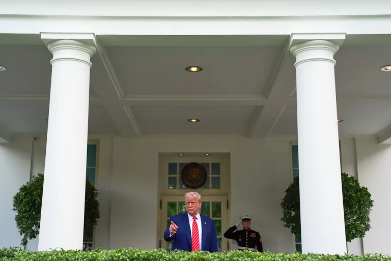 President Donald Trump speaks to reporters outside the West Wing of the White House.