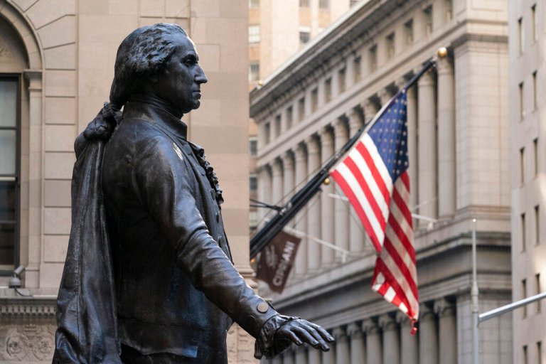 A statue of George Washington stands in front of Federal Hall National Memorial.