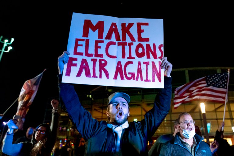 Jake Contos, a supporter of President Donald Trump, chants during a protest against the election results outside the central counting board at the TCF Center in Detroit.