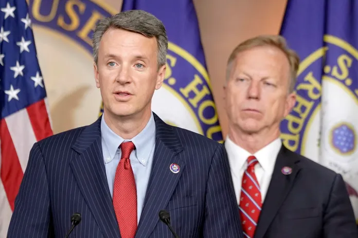 Rep. Ben Cline, R-Va., left, speaks as Rep. Kevin Hern, R-Okla., right, listens during a Republican Study Committee news conference on the FY2024 budget, Wednesday, June 14, 2023, on Capitol Hill in Washington. (AP Photo/Mariam Zuhaib)